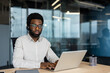 © Liubomir - Professional customer support representative working on laptop in modern office setting