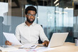 © Liubomir - Professional man working at desk with laptop and documents in modern office