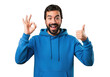 © MdMashud - Excited bearded man in blue hoodie gives thumbs up and ok gesture transparent background