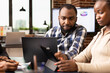 © DC Studio - Closeup of black male manager with laptop, reviewing marketing strategy and plans of female employee in office. African american business professionals preparing and analyzing financial reports.