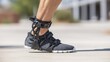 © Justlight - Crisp medium view of an adjustable ankle exoskeleton brace on an active leg focused on the devices hinges with the foot and environment softly out of focus to showcase chronic
