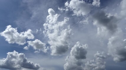 Wall Mural - Time-lapse of moving fluffy clouds and white cumulus clouds in the blue sky