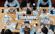 © InfiniteFlow - A top-down view of diverse professionals collaborating during a training session, utilizing technology and innovative ideas for skill enhancement and knowledge sharing. Amity