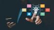 © 9Thaweekiat - A businessman touches a glowing AI lightbulb icon on a futuristic digital interface, surrounded by technology symbols, representing innovation and business solutions through artificial intelligence.