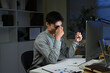 © Stella 16 - Tired, overworked and man with laptop, night or web designer with color sensitivity, sore or vision. Working late, employee and person with itching eyes, strain or poor lighting for glasses in office