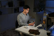 © Stella 16 - Staying late to get it done. Shot of a young businessman using a computer at his desk during a late night at work.