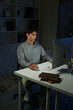 © Stella 16 - Staying late to get it done. Shot of a young businessman using a computer at his desk during a late night at work.