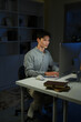 © Stella 16 - Businessman working on laptop in night office.