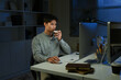 © Stella 16 - Businessman with cup of coffee working on computer in office at night