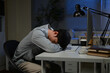© Stella 16 - Tired Asian business man falling asleep at table Alone Working holding his head on hands after late night work. asian male employee