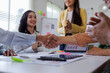 © David - Meeting, partnership and asian business people shaking hands in the office for a deal, professional and employees with handshake for agreement, welcome or greeting.