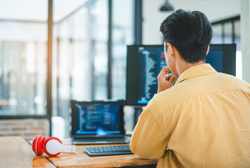 Young programmer working on coding, software development and web design in software company office.Concept technology development