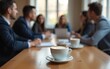 © wang - A cup of coffee with latte art on a wooden table, blurred background with professionals networking during conference. Business people at coffee break, networking, socialising indoors. High quality