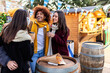 © Xavier Lorenzo - Multiracial young group of friends having fun together at christmas market on winter holidays