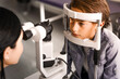 © InsideCreativeHouse - Female doctor ophthalmologist doing basic eye examination of cute boy in modern clinic. Caucasian female optician checking on kid patient vision eyesight. Myopia glaucoma prevention concept