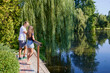 © czamfir - Father and daughter in the park on a summer morning spending time together enjoying nature.