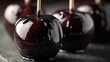 © fivan - A candy apples coated in black caramel, moody shot with glossy highlights