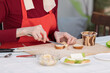 © Nobilior - Elderly woman preparing a butter sandwich