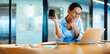 © (JLco) Julia Amaral - Smiling woman enjoying coffee while working on a laptop at her desk