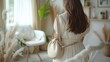 © Emaan Malik - Minimalist handbag with a crossbody strap hanging on a white chair in a modern interior creating a stylish and functional accessory for everyday use