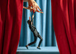 © VISTA by Westend61 - Businessman marionette controlled by a hand on theater stage