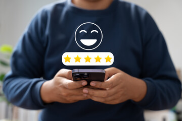 Canvas Print - Happy customer providing 5-star review via mobile application after receiving outstanding service and quality product. Online customer feedback plays crucial role in business ranking, Consumer trust