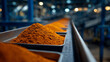© Maksym - Close-up perspective along line of metal trays with bright paprika powder, factory lighting emphasizing texture, conveying large-scale, automated culinary ingredient processing