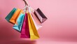© John - colorful shopping bags falling on pink background