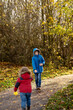 © Tatjana - Brother and sister playing in the autumn park surrounded by golden leaves.