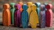 © JovialFox - Colorful wooden figures represent diversity, inclusion in workplace setting. Conceptual image shows varied people standing together. Image illustrates diversity concept, tolerance. Potential