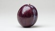 © yasiryasir - Single ripe plum, dark purple skin with a small stem, on white