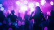 © Studicon - An image shows a woman's silhouette from behind at a concert with purple and white lights; other blurry figures are dancing.