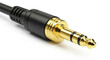 © ray - Detailed close up of a gold plated 35mm audio jack and its black cable connector.