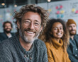 © CHANX789X - Confident, smiling man with glasses and beard in meeting with colleagues