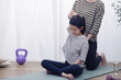© DN6 - A mother is training her daughter, A mother guides her cheerful daughter through a stretching routine at home, exercising for a healthy lifestyle concept