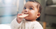 © Jeff Bergen/peopleimages.com - Food, cute and cookie with baby in home for teething biscuit, nutrition and calcium snack for growth. Eating, weaning rusk and healthy diet with hungry kid in living room of house for development