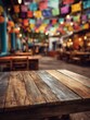 © Johannes - closeup of wooden table at mexican party colorful flags decor create festive mood empty tables chairs on blurred background vibrant holiday celebration traditional culture at restaurant mockup