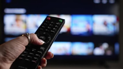 Person Using Remote To Navigate Television Interface with Bright Home Screen