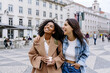 © Westend61 - Happy multiracial friends enjoying at town square