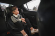 © geargodz - toddler girl sitting in car seat and looking out of the window, safety baby chair travelling
