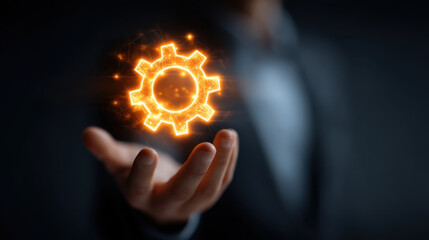 Wall Mural - hand holding glowing gear symbolizing innovation and technology, representing progress and creativit