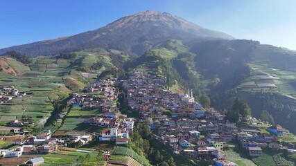 Wall Mural - Stunning countryside view of mountain village covered in in the morning. Green agricultural terraces stretch across the hills. Nepal Van Java, Indonesia.