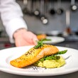 © Heriics - Chef serving plated salmon and asparagus
