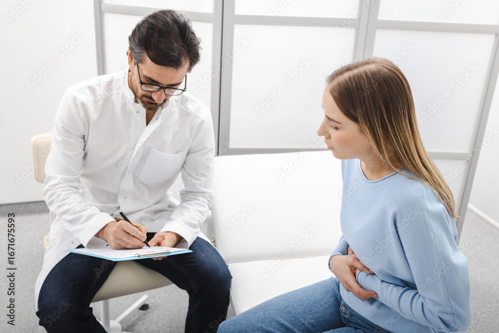Doctor prescribes treatment for female patient with abdominal pain. Gastroenterology
