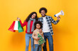 © Atstock Productions - Happy African American family in festive Christmas celebration concept, studio shot on yellow color isolated  background
