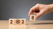© Image Alchemy - New year goals setting concept changing wooden blocks from year to year business target planning