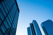 © yaqui_villegas - Blue sky with modern Frankfurt skyscrapers in financial district, corporate identity symbolizing finance, economy, global business investment and development resilience