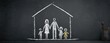 © KIKI - Chalk drawing of a family inside a house on a chalkboard. Parents, children, home concept