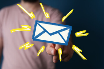 Hand pointing at glowing email icon, signifying new message or notification. Modern communication concept.