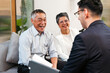 © artitwpd - Cheerful senior couple meets financial advisor in modern office, discussing retirement planning, investment options, and insurance. Consultation helps clients manage finance with expert guidance.